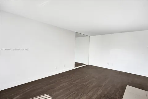 a kitchen with granite countertop white cabinets and stainless steel appliances