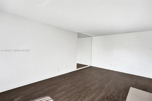a kitchen with granite countertop white cabinets and stainless steel appliances