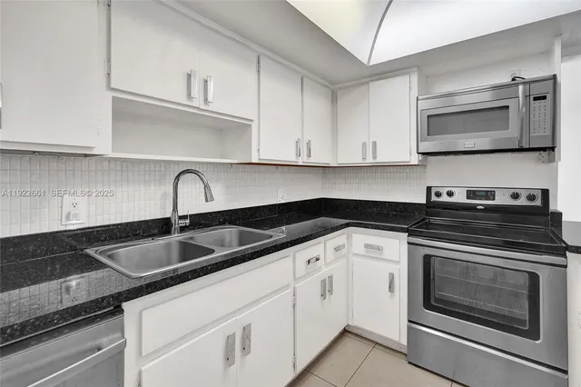 a kitchen that has a refrigerator and a stove