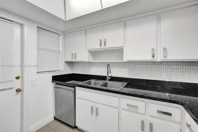 a kitchen with stainless steel appliances granite countertop a sink and a stove