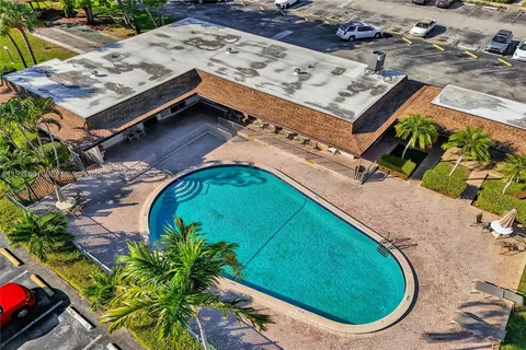 an aerial view of a house with a swimming pool