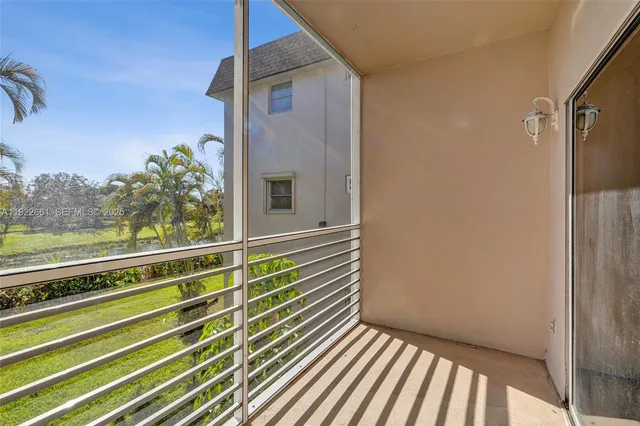 a bathroom with a glass shower door and a window