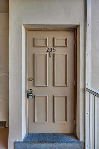 a view of kitchen with sink and refrigerator