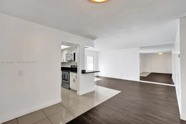 a view of a kitchen with furniture and wooden floor
