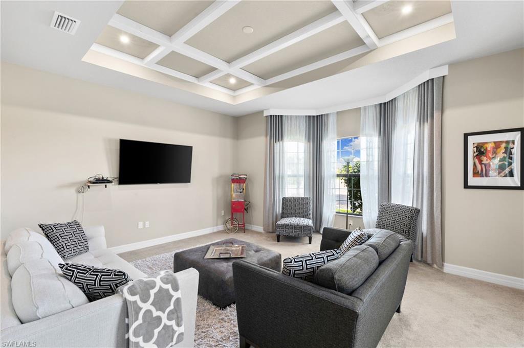 4370 Caldera Circle Naples, FL 34119 - Photo 11 of 35 a living room with furniture and a flat screen tv