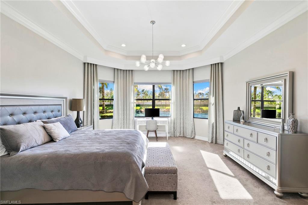 4370 Caldera Circle Naples, FL 34119 - Photo 13 of 35 a spacious bedroom with a large bed and a window