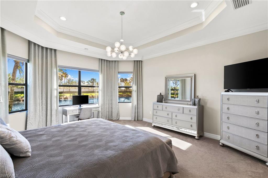 4370 Caldera Circle Naples, FL 34119 - Photo 14 of 35 a bedroom with a bed and a flat screen tv in it