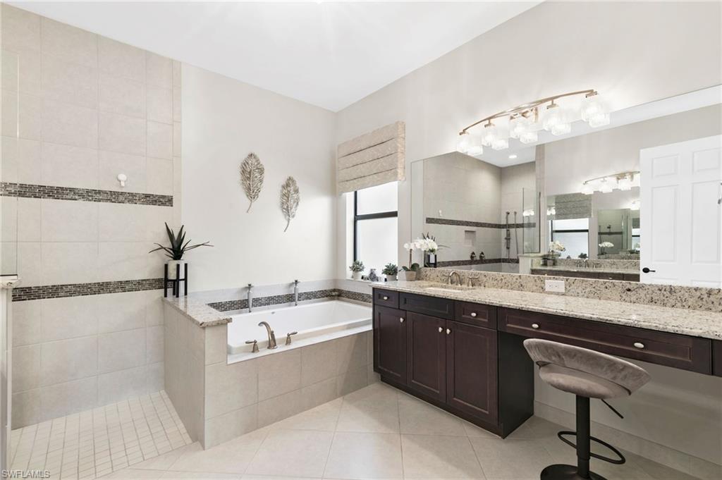 4370 Caldera Circle Naples, FL 34119 - Photo 16 of 35 a large kitchen with a sink and cabinets