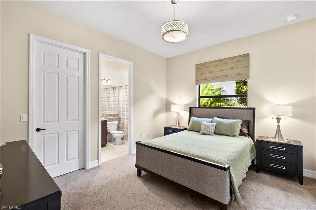 4370 Caldera Circle Naples, FL 34119 - Photo 17 of 35 a bedroom with a bed and a lamp
