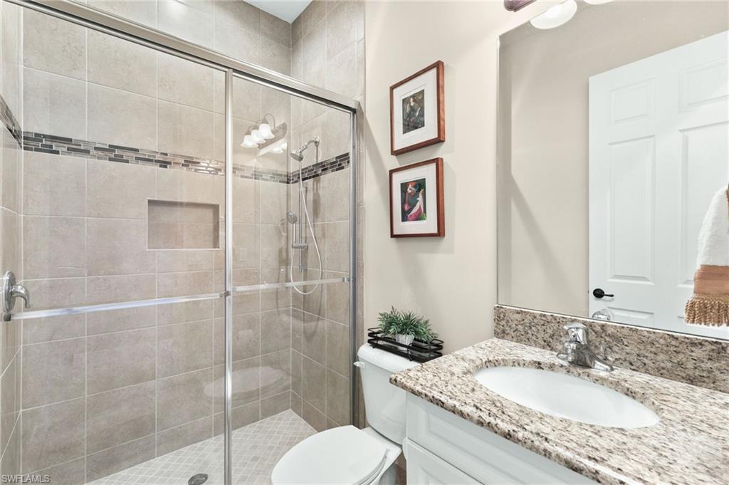 4370 Caldera Circle Naples, FL 34119 - Photo 20 of 35 a bathroom with a granite countertop sink toilet and shower
