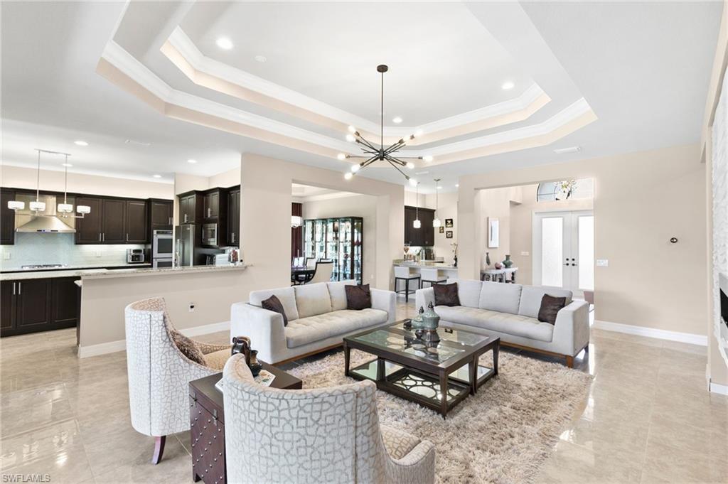 4370 Caldera Circle Naples, FL 34119 - Photo 2 of 35 a living room with furniture and view of kitchen