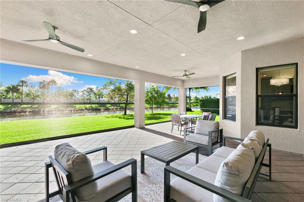 4370 Caldera Circle Naples, FL 34119 - Photo 22 of 35 a view of a patio with dining table and chairs