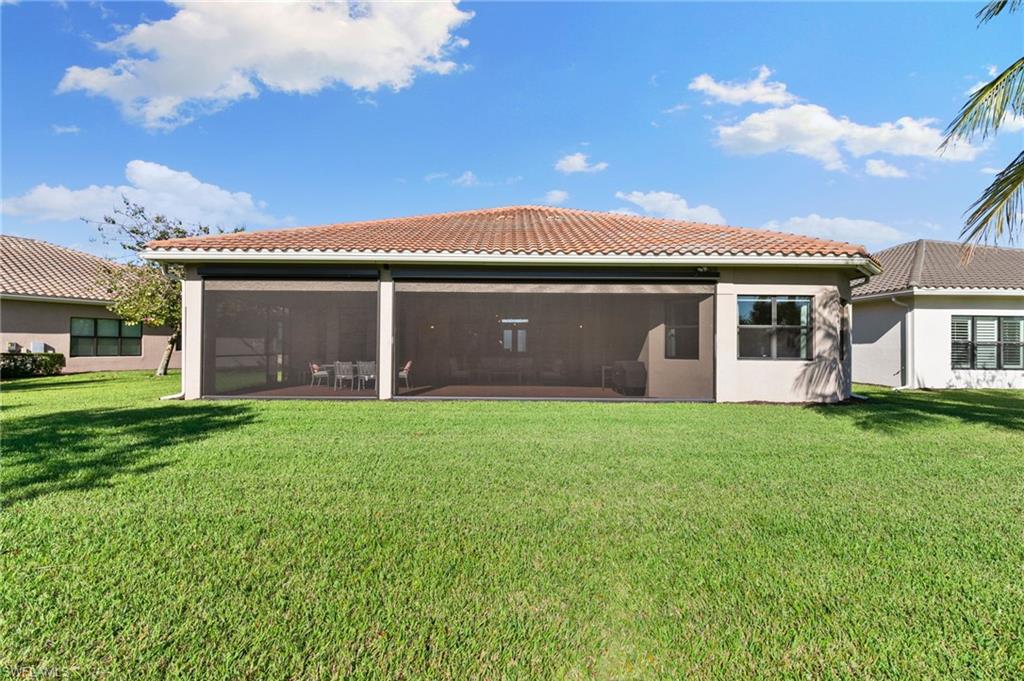 4370 Caldera Circle Naples, FL 34119 - Photo 25 of 35 front view of a house with a garden