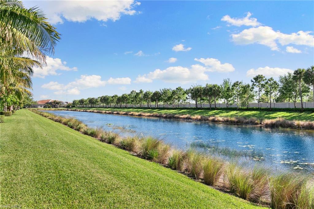 4370 Caldera Circle Naples, FL 34119 - Photo 26 of 35 a view of a lake with houses in the back