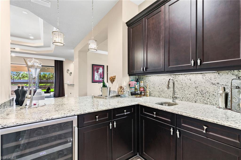 4370 Caldera Circle Naples, FL 34119 - Photo 10 of 35 a kitchen with granite countertop stainless steel appliances sink and cabinets