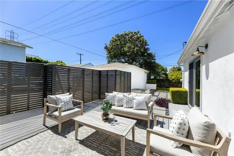 a view of a patio with table and chairs and potted plants