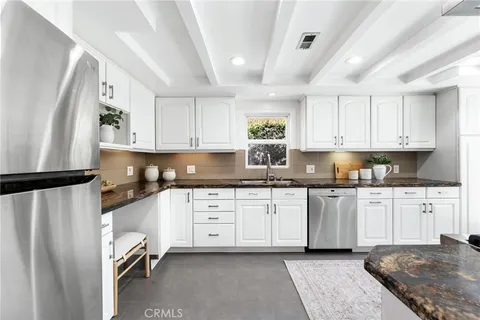 a kitchen with a sink and a stove