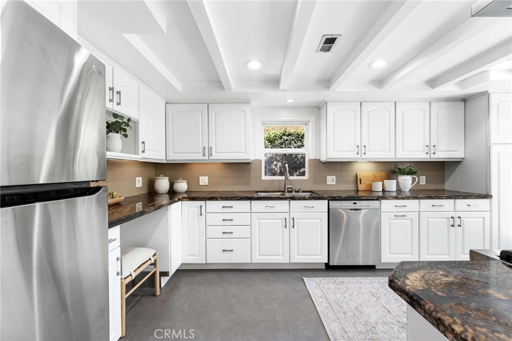 3219 Gibson Place Redondo Beach, CA 90278 - Photo 22 of 47 a kitchen with stainless steel appliances granite countertop a refrigerator sink and cabinets