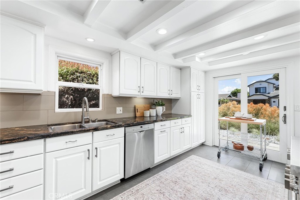 3219 Gibson Place Redondo Beach, CA 90278 - Photo 23 of 47 a kitchen with granite countertop white cabinets and window