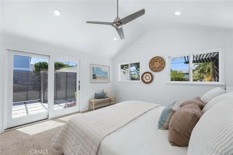 a bedroom with a bed and a ceiling fan