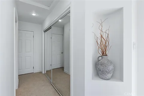 a bedroom with a bed and a potted plant