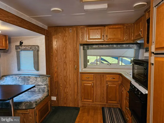 a kitchen with stainless steel appliances granite countertop wooden cabinets a stove top oven a sink and dishwasher