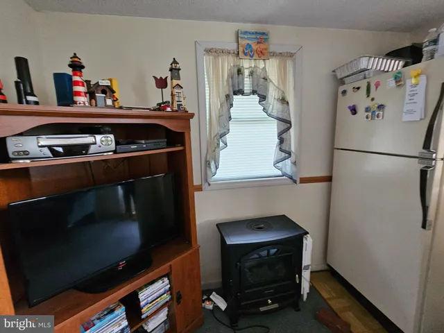 a kitchen with a refrigerator and a stove