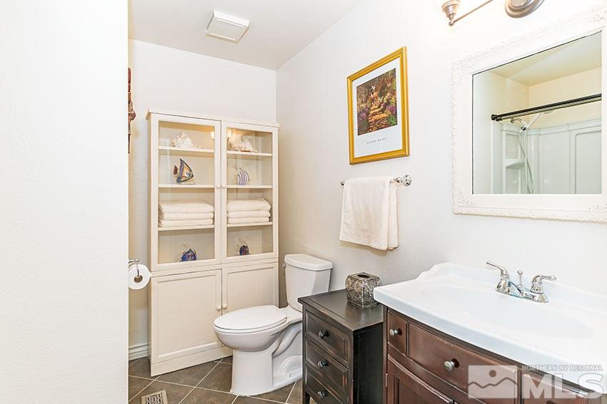 14345 Chamy Drive Reno, NV 89521 - Photo 11 of 15 a bathroom with a sink a toilet and a mirror