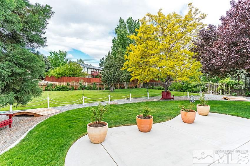 14345 Chamy Drive Reno, NV 89521 - Photo 7 of 15 a view of a garden with potted plants and large trees