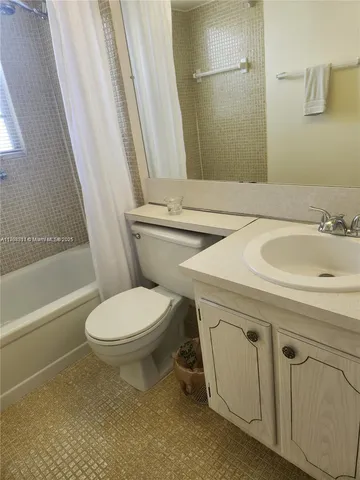 a bathroom with a sink a toilet and a bathtub