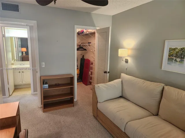 a living room with furniture and a walk in closet