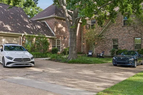 a backyard of a house with a yard and outdoor seating