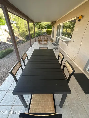 a view of a patio with table and chairs and wooden floor