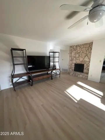 a living room with furniture and a fireplace