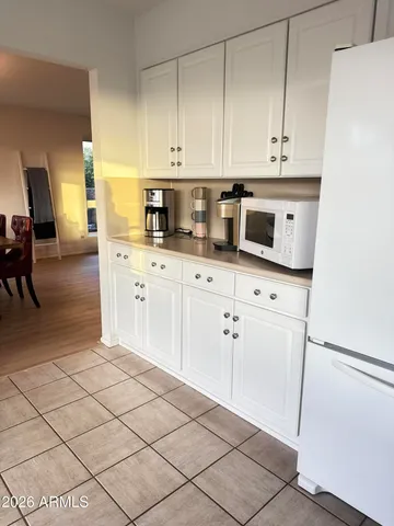 a kitchen with stainless steel appliances white cabinets and a stove top oven