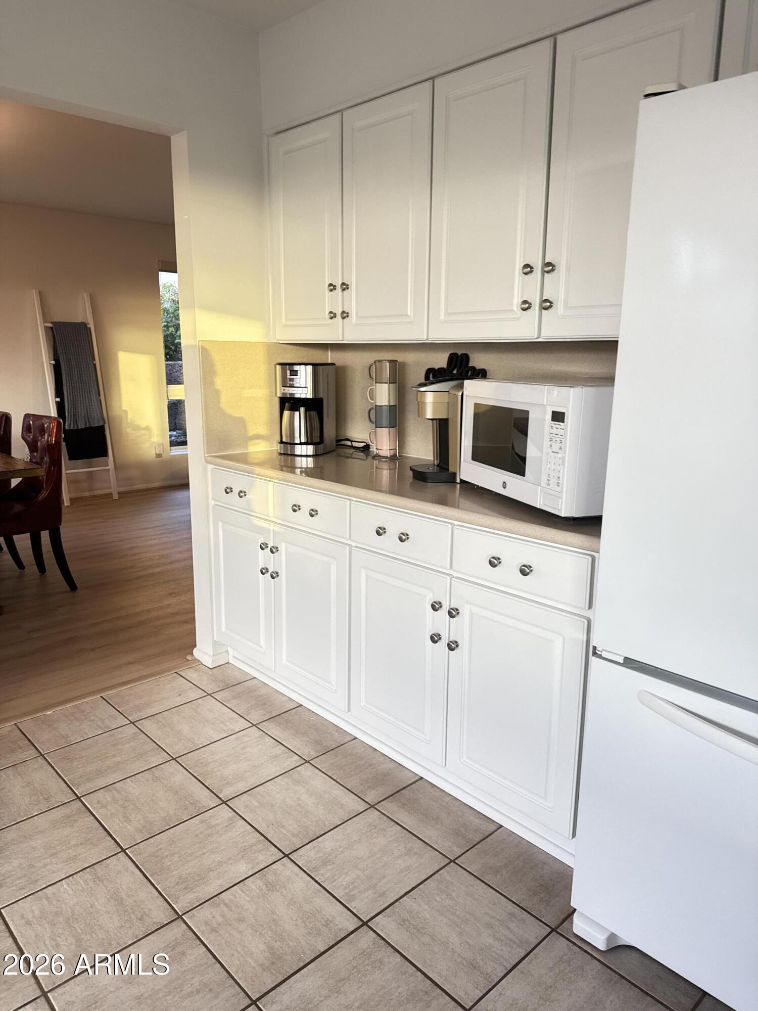 6802 North 26th Street Phoenix, AZ 85016 - Photo 14 of 39 a kitchen with stainless steel appliances white cabinets and a stove top oven