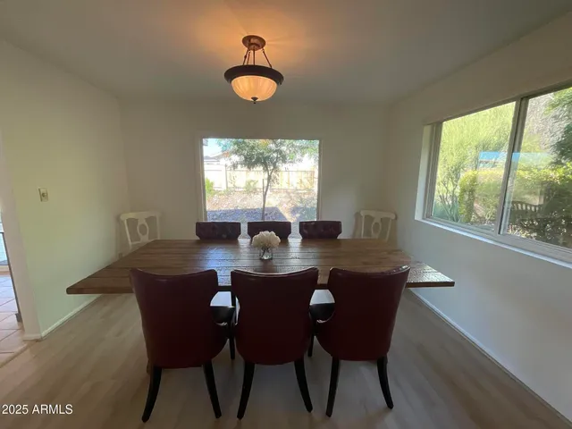 a view of a dining room with a table and chairs