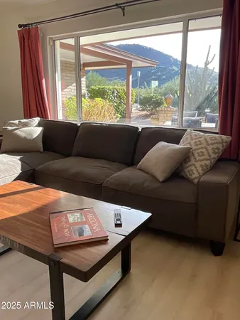 a living room with furniture and a large window