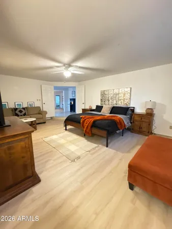 a bedroom with furniture and a view of kitchen