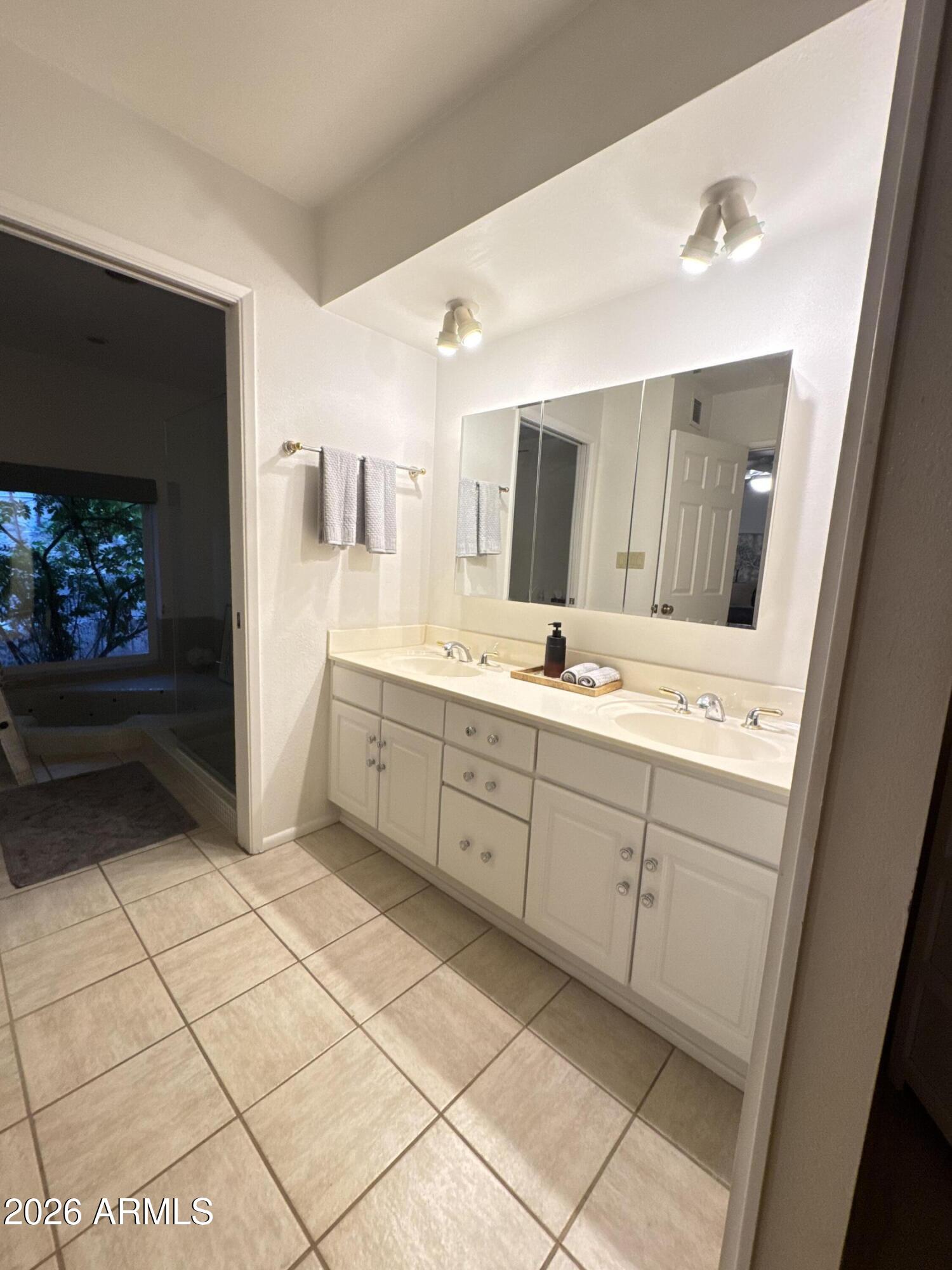 6802 North 26th Street Phoenix, AZ 85016 - Photo 20 of 39 a spacious bathroom with a sink a mirror and a shower
