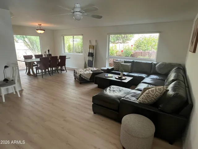 a living room with furniture and wooden floor
