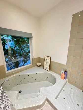 a bathroom with a tub and a sink