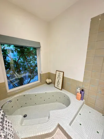 a bedroom with two beds and a desk