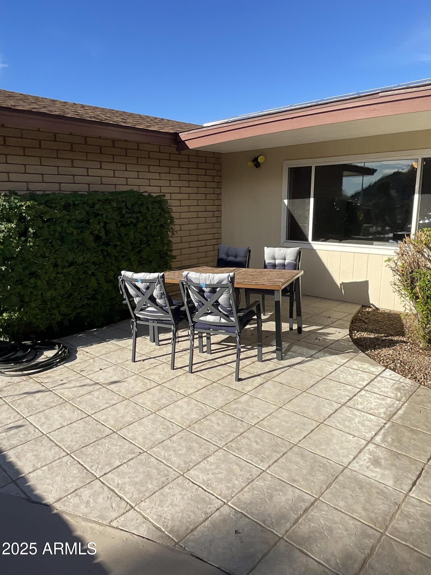 6802 North 26th Street Phoenix, AZ 85016 - Photo 31 of 39 a view of a patio with table and chairs with wooden floor and fence