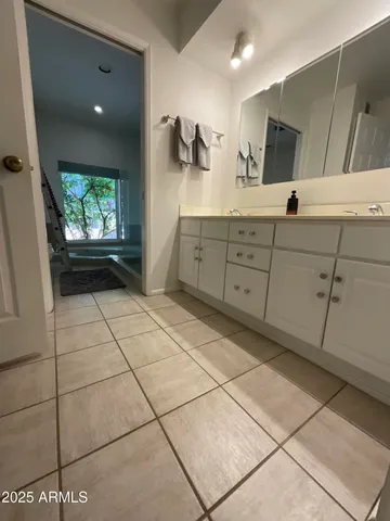 a spacious bathroom with a mirror and a shower