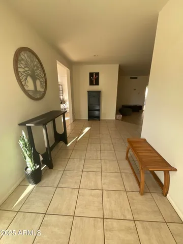 a view of a livingroom with furniture and a hallway