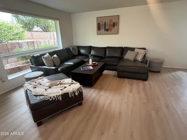 a living room with furniture and a large window