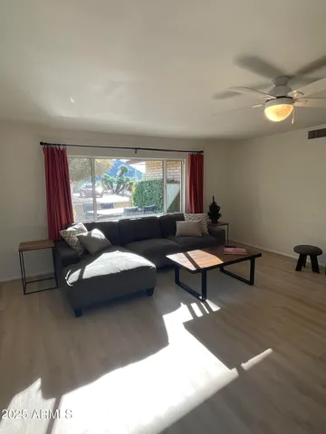 a living room with furniture and a large window