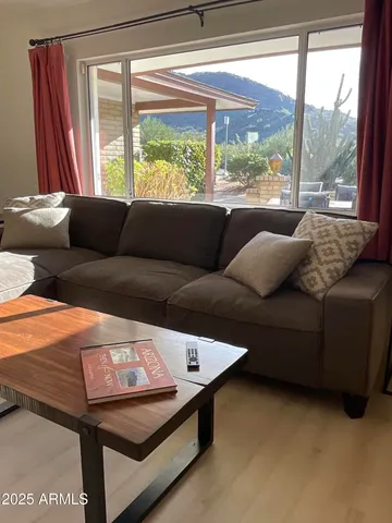 a living room with furniture and a large window