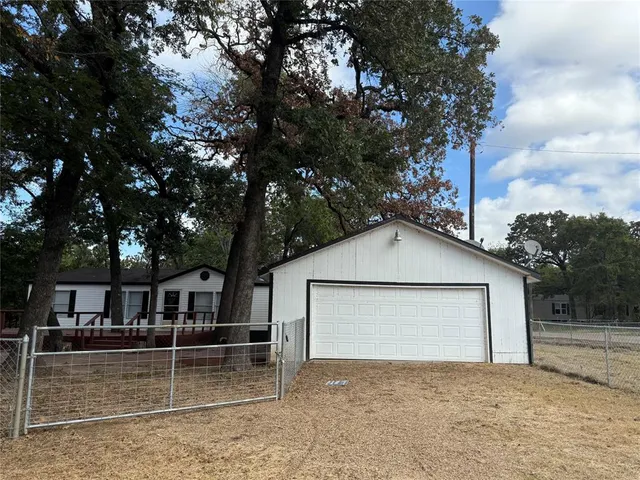 a white house that has a tree in front of it